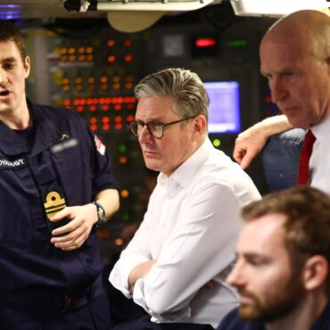 PM visits nuclear-armed submarine as tensions grow with Russia