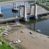 Crossing closed and rail services suspended after boat hits bridge