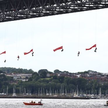 Ten Greenpeace activists arrested after suspending themselves from bridge