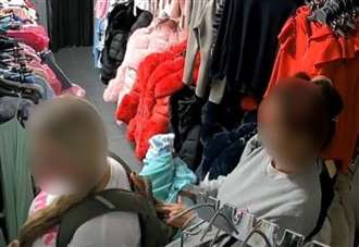 CCTV captures ‘blatant’ shoplifters stuff children’s clothes into rucksack