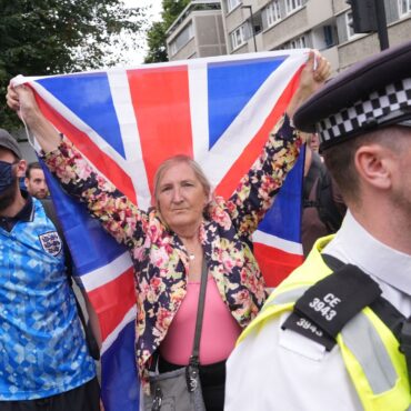 Rival groups face off outside migrant hotel – as asylum seekers ‘blow kisses’ at protesters
