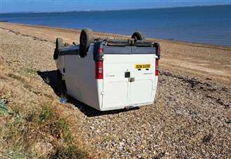 Police investigation launched after van found upside down on beach