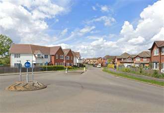 Two people freed from overturned car after roundabout crash