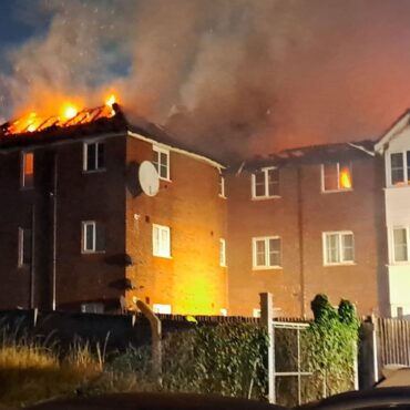 Three children taken to hospital after fire tears through three-storey block of flats