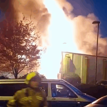 Around 100 firefighters tackle large blaze which engulfed shop