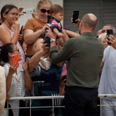 Prince William wins hearts as he cuddles baby handed to him on Brazilian island