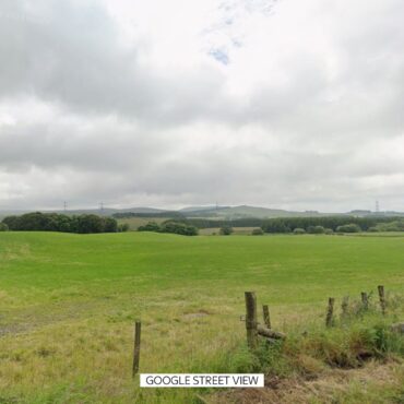 Three men arrested after body found in field