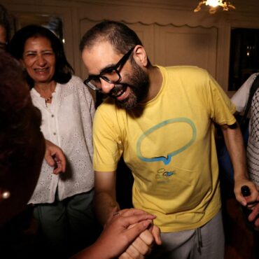 British-Egyptian activist returns to the UK and reunites with family after prison release