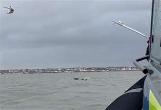 Incredible footage shows moment helicopter and marine officers rescue men stranded at sea