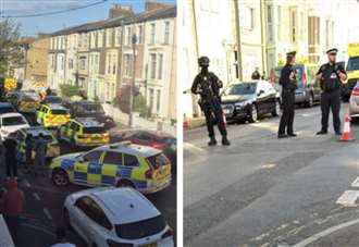 Armed police guard sealed off street as major emergency response unfolds