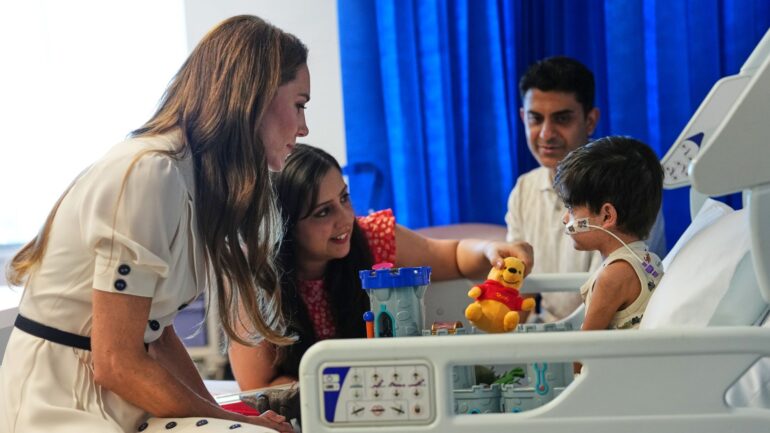 Kate talks dinosaurs and blows kisses as she meets boy, 3, with rare condition