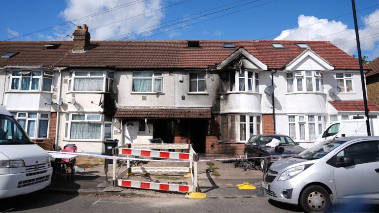 Man arrested on suspicion of murder after house fire kills one and injures eight