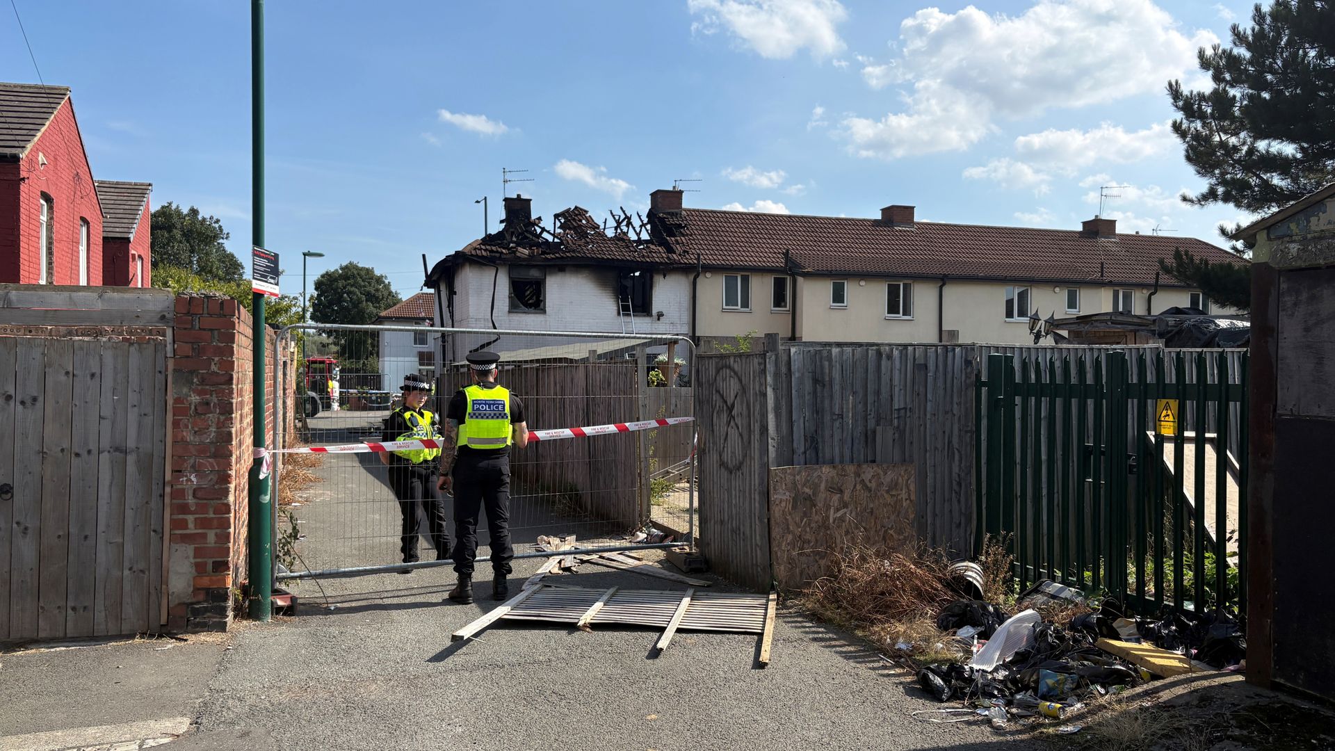 Two people die and woman critical after house fire ‘possibly linked to organised crime’